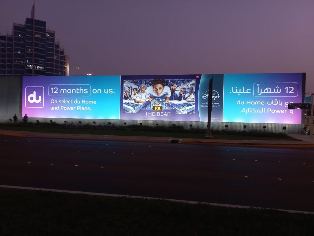 Outdoor Billboard Advertising UAE on a digital hoarding delivering high-impact visibility during evening traffic hours