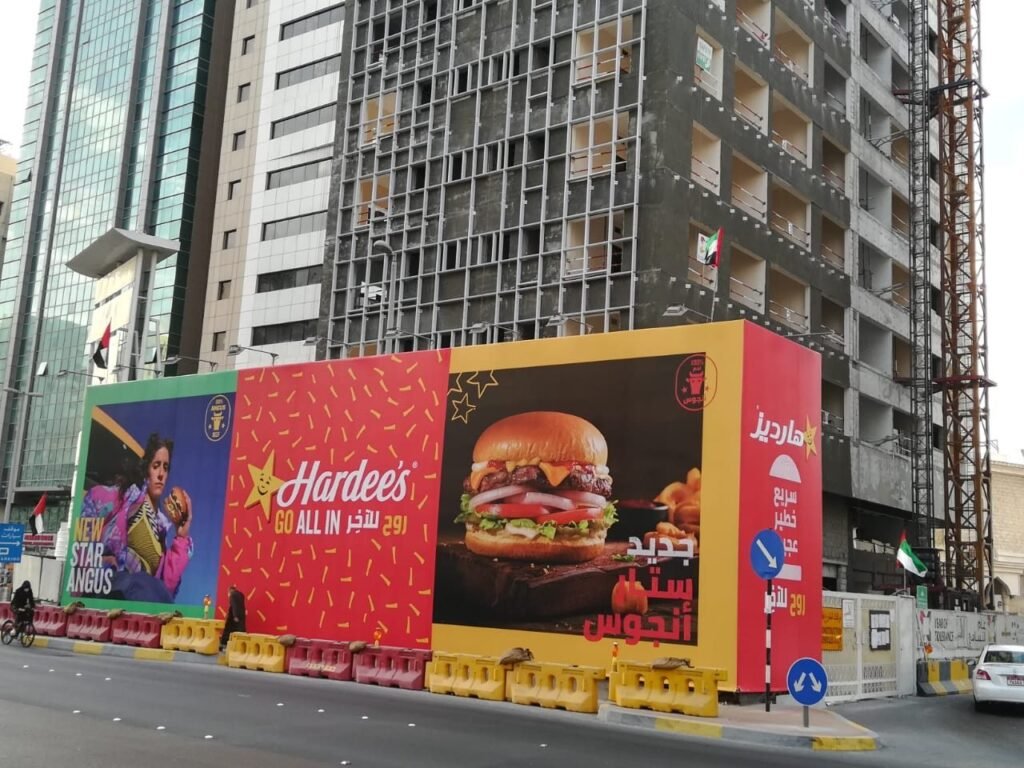 Outdoor Billboard Advertising UAE showcasing a large-format hoarding beside commercial high-rise buildings