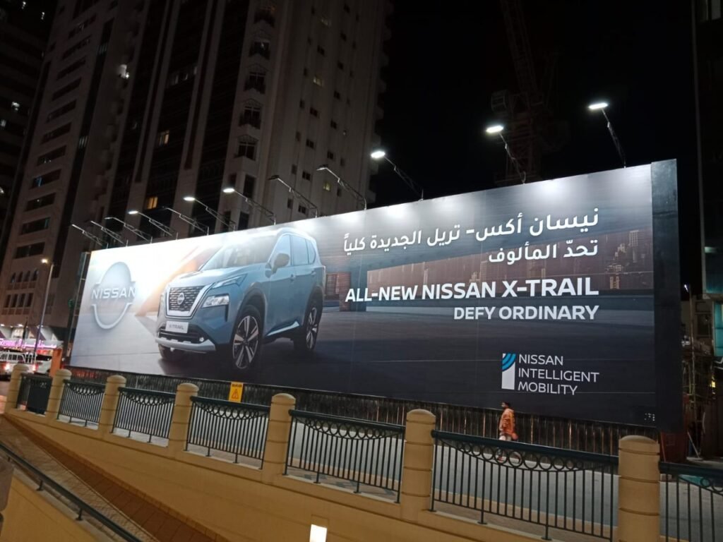 Outdoor Billboard Advertising UAE highlighting an automotive brand through illuminated nighttime roadside branding