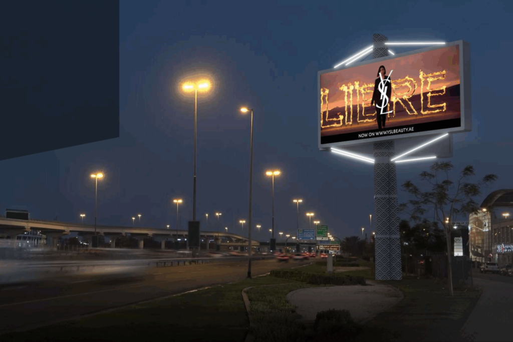 Illuminated roadside digital billboard at night showcasing premium Dubai DOOH screens advertising in a fast-moving traffic corridor