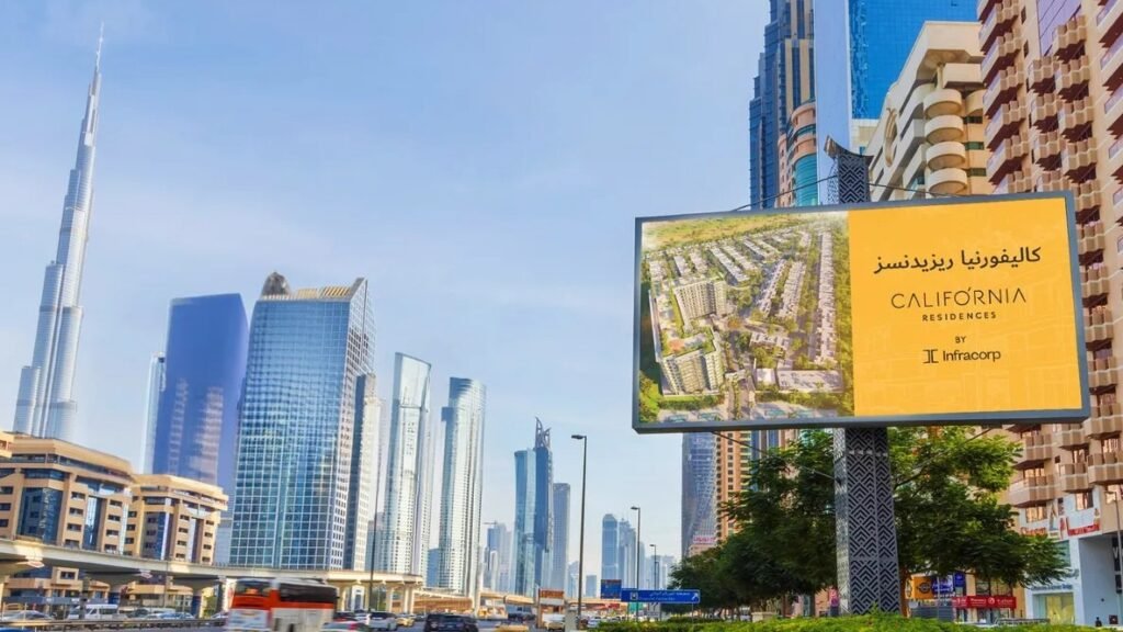 Standalone outdoor billboard displaying real estate advertisement against modern city skyline