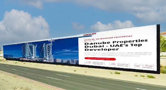 Large-format roadside billboard showcasing outdoor advertising Ras Al Khaimah with high-visibility real estate branding along a major highway